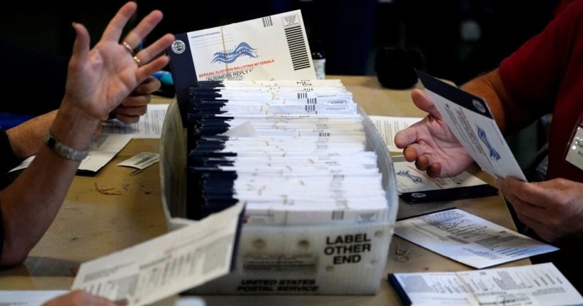 In this Nov. 4, 2020, file photo, Chester County election workers process mail-in and absentee ballots for the 2020 general election in the United States at West Chester University in West Chester, Pennsylvania.