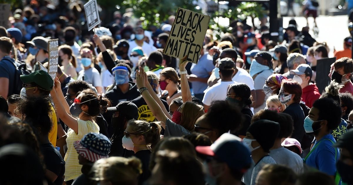 A person holds a "Black Lives Matter" during a demonstration near the White House in Washington on June 1, 2020.
