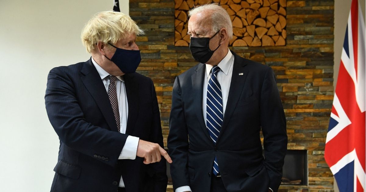 Britain's Prime Minister Boris Johnson, left, and U.S. President Joe Biden view a display of documents relating to the original Atlantic Charter ahead of their meeting at Carbis Bay, Cornwall, on Thursday, ahead of the three-day G7 summit.