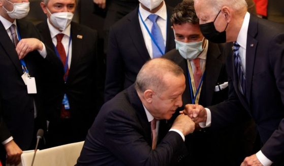 Turkey's President Recep Tayyip Erdogan fist bumps with President Joe Biden as he stands up to greet him during a plenary session at a NATO summit in Brussels on Monday.