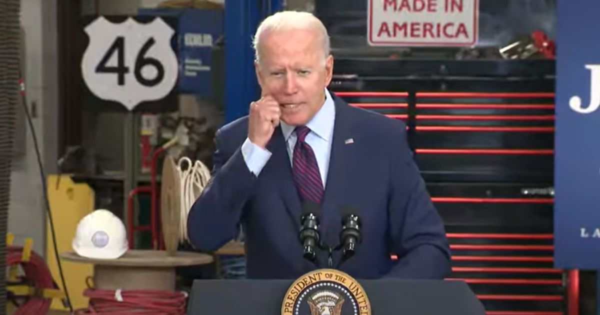 President Joe Biden grabs his cheek during an infrastructure speech at the La Crosse Municipal Transit Utility in Wisconsin on Tuesday.