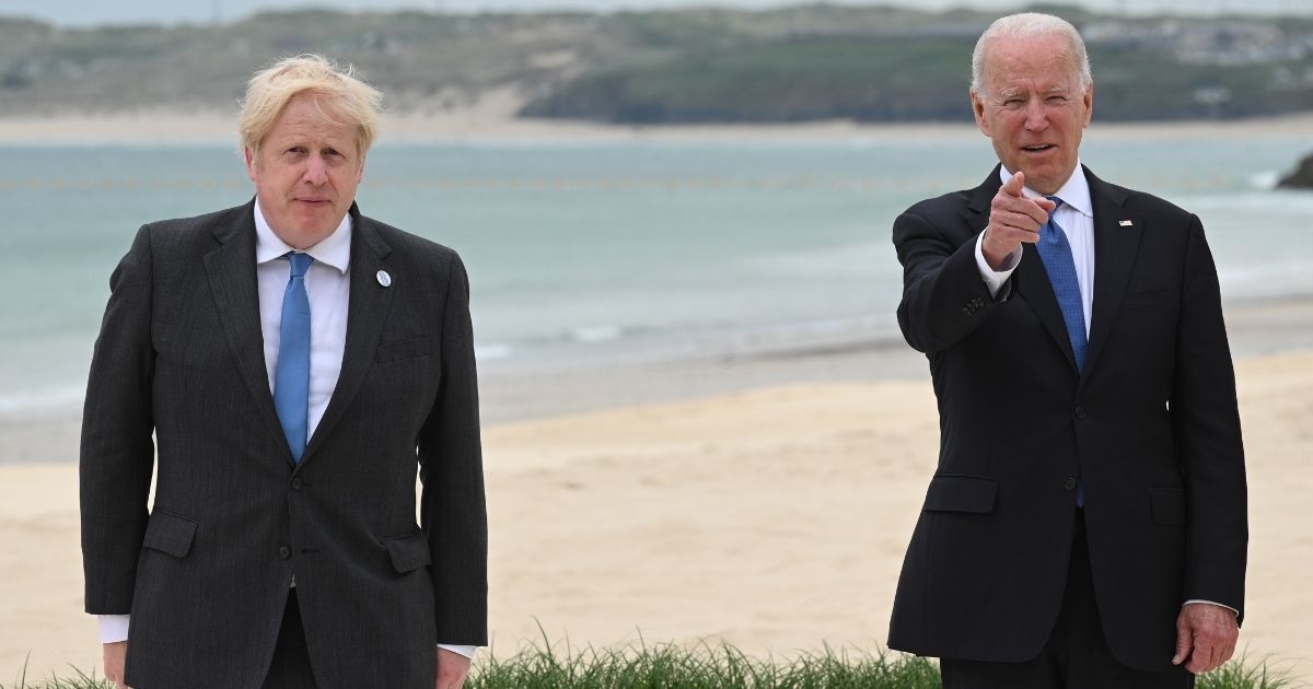 U.K. Prime Minister Boris Johnson, left, and U.S. President Joe Biden pose during the leaders official welcome and family photo during the G7 Summit on Friday in Cornwall, England.
