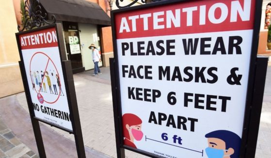 Signs telling people to wear face masks are seen at a mall in Monterey Park, California, on June 14, 2021.