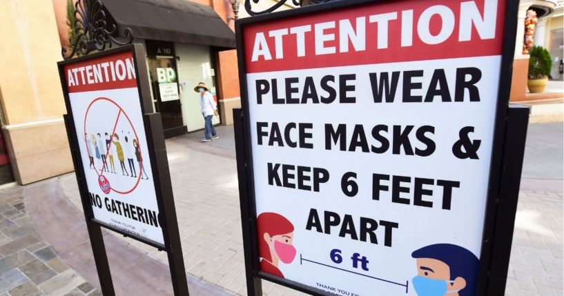 Signs telling people to wear face masks are seen at a mall in Monterey Park, California, on June 14, 2021.