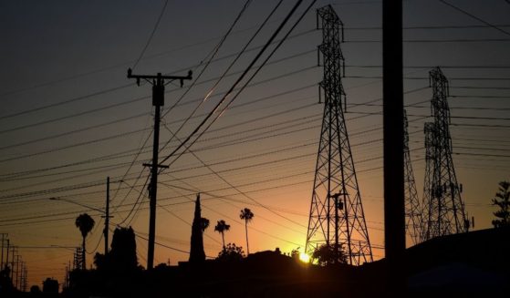 The sun sets behind power lines in Rosemead, California, on Monday.
