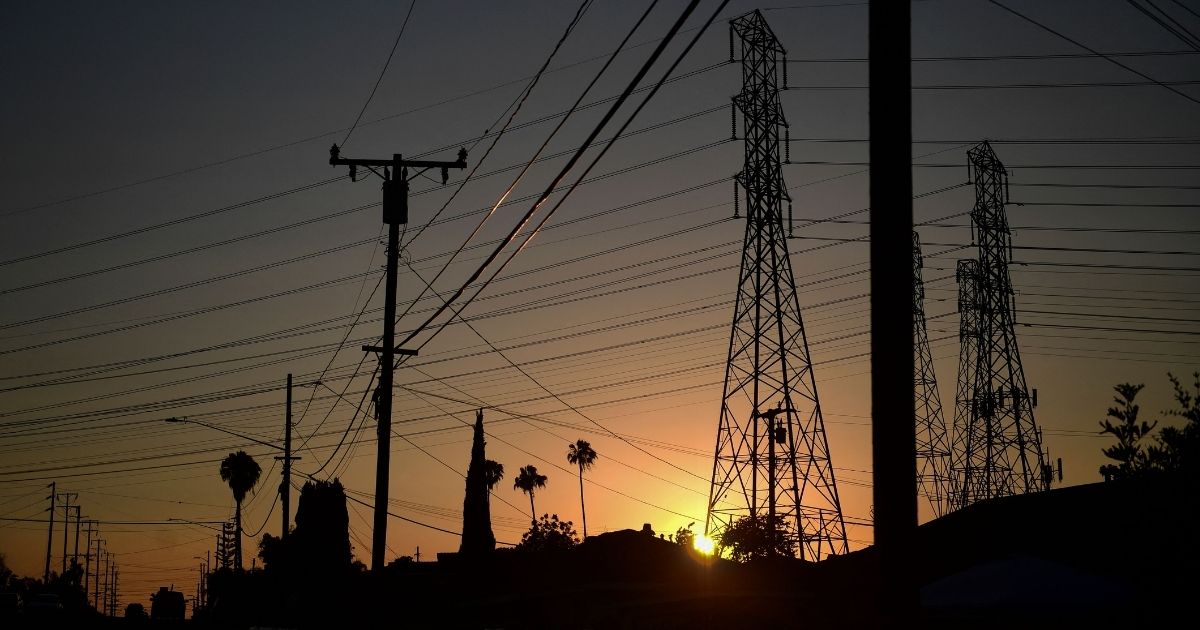 The sun sets behind power lines in Rosemead, California, on Monday.