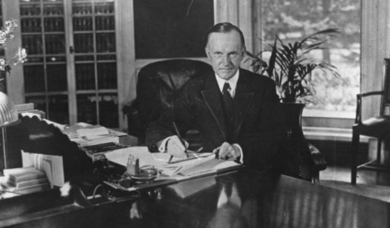 Former President Calvin Coolidge sits at his desk in the White House, in Washington D.C., on Aug. 15, 1923.