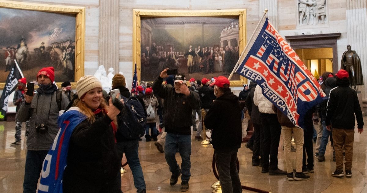 People walk around the Rotunda of the U.S. Capitol during the incursion on Jan. 6.