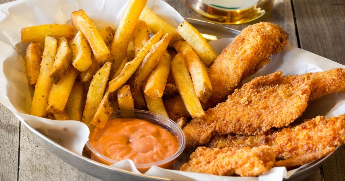 A basket of chicken fingers, fries and sauce is pictured in the stock image above.