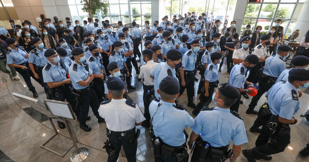 Police officers conduct a raid at the offices of the Apple Daily newspaper on Thursday in Hong Kong.