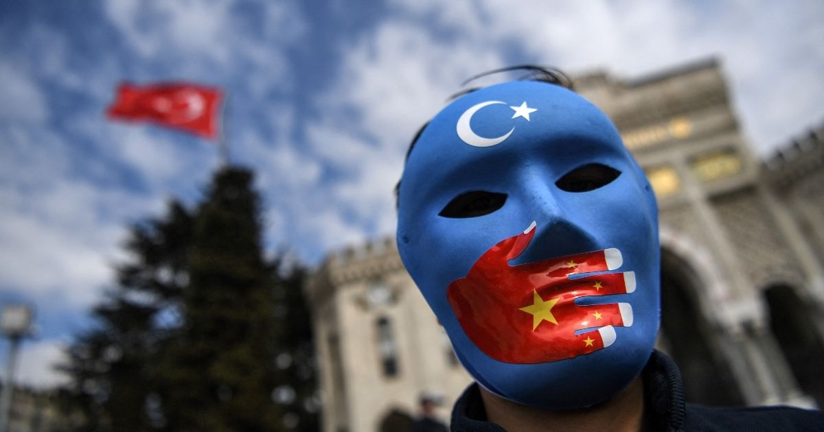 A demonstrator wearing a mask takes part in a protest in support of Uighurs on April 1, 2021, in Istanbul.