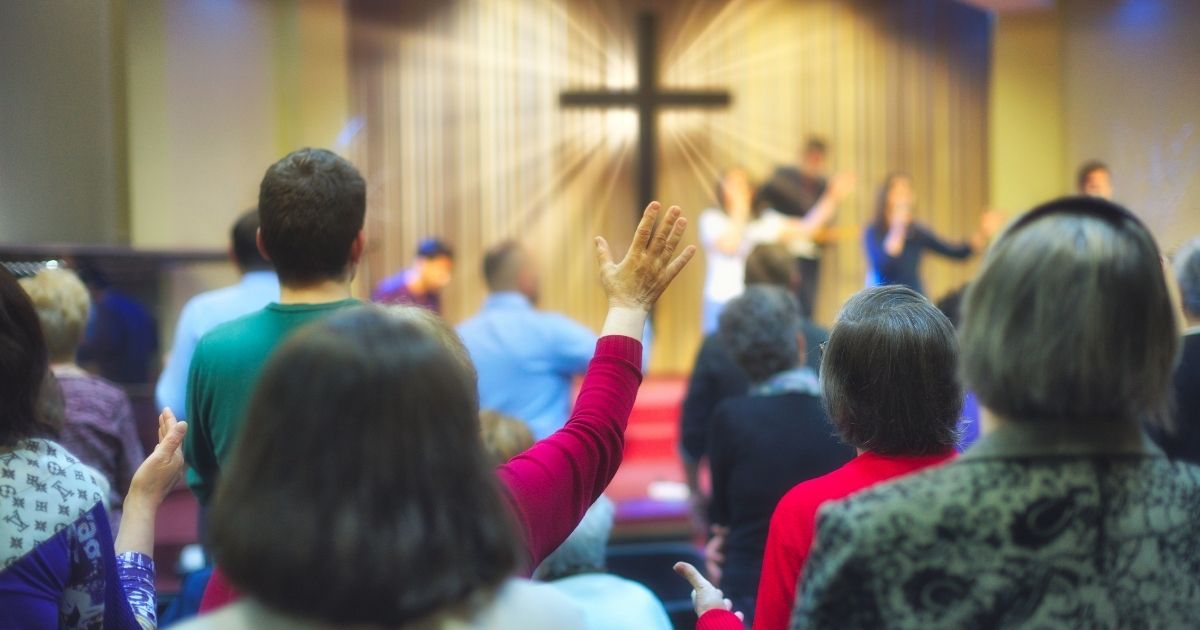 A Christian congregation worships in the stock image above.