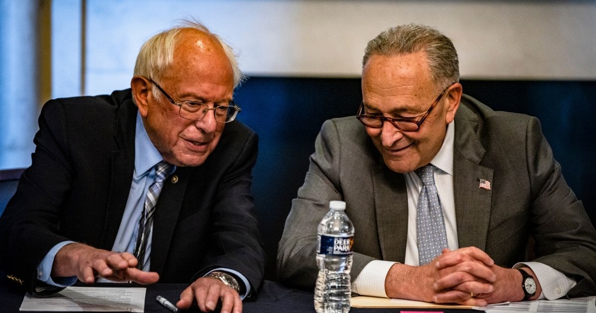 Senate Majority Leader Chuck Schumer, right, and Sen. Bernie Sanders hold a meeting with Senate Budget Committee Democrats at the U.S. Capitol on Wednesday in Washington, D.C.