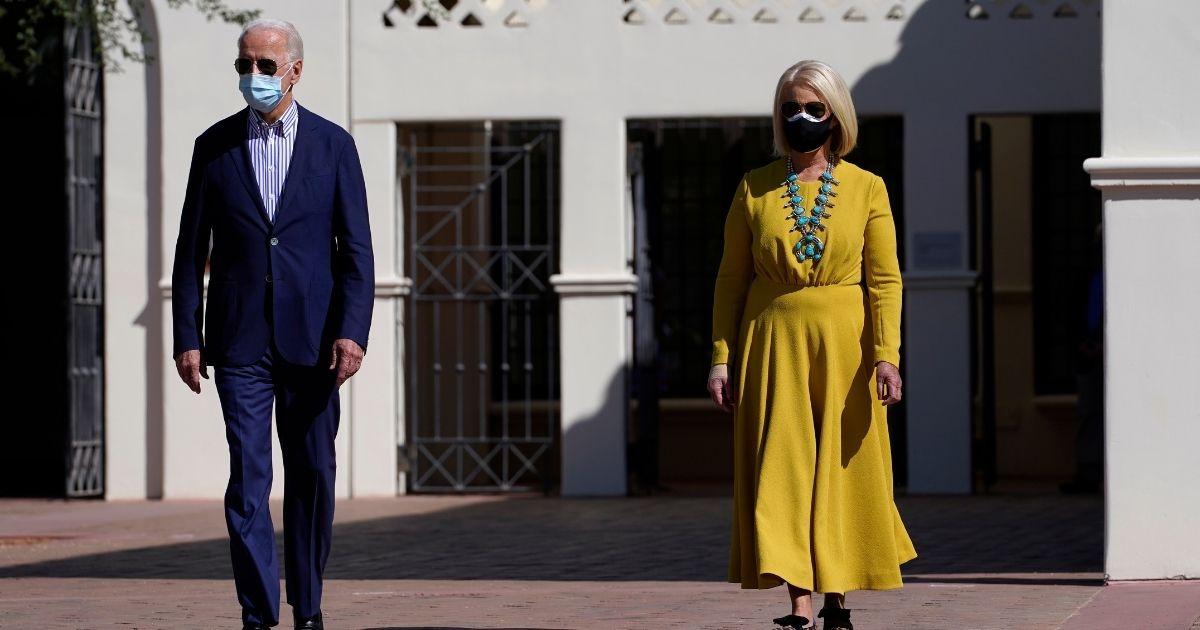 Then-Democratic presidential candidate Joe Biden, left, walks with Cindy McCain as they visit the Heard Museum in Phoenix on Oct. 8, 2020.