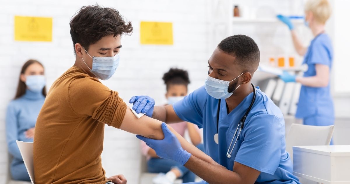 The above stock photo shows a young man getting the coronavirus vaccine.