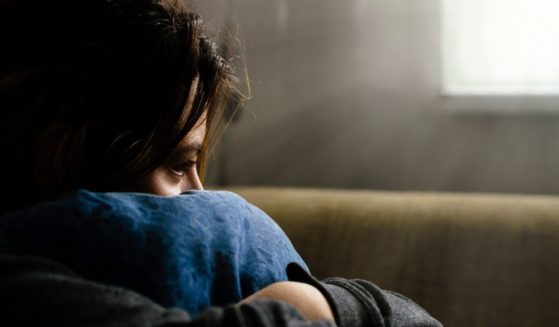 The above stock photo shows a depressed teen girl.