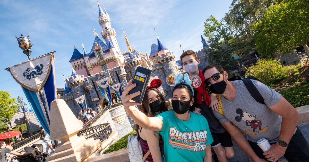 In this handout photo provided by Disneyland Resort, The Wotter family of Lake Elsinore, California, takes a selfie photo in front of Sleeping Beauty Castle as Disneyland Park at the Disneyland Resort on April 30, 2021, in Anaheim, California.