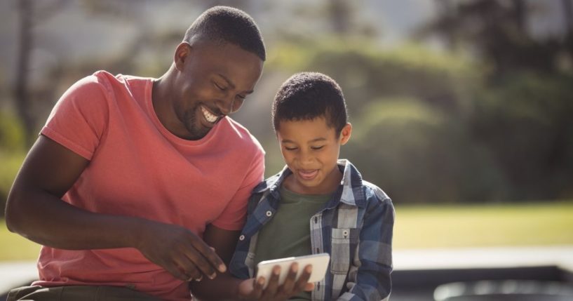 A father and son are pictured spending time together in the stock image above.
