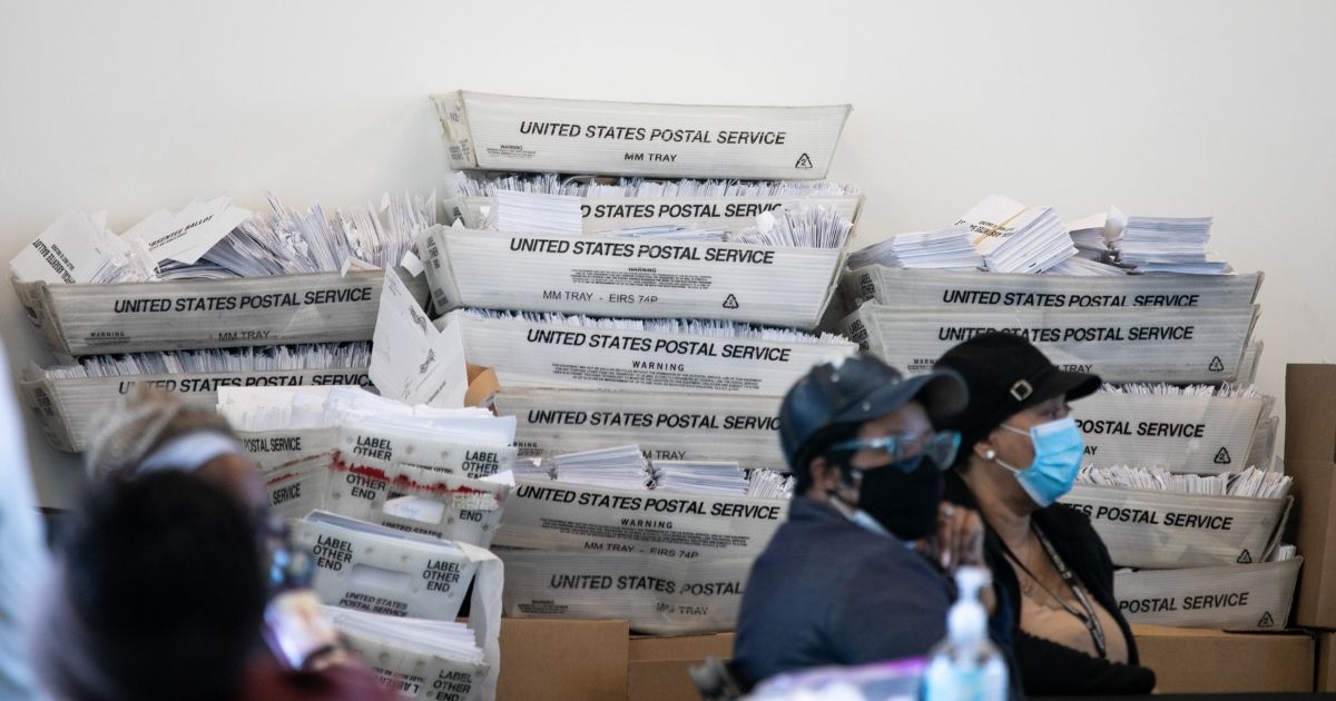 Envelopes for absentee ballots sit in stacked boxes as Fulton County workers count absentee ballots at State Farm Arena in Atlanta on Nov. 6.