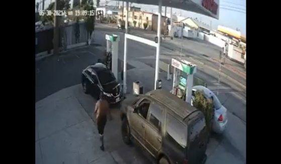A man identified as 37-year-old Antoine Rainey approaches a woman at a gas station in Gardena, California.