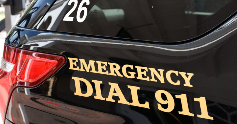A police car with 'Emergency Dial 911' on its side in Santa Fe, New Mexico.