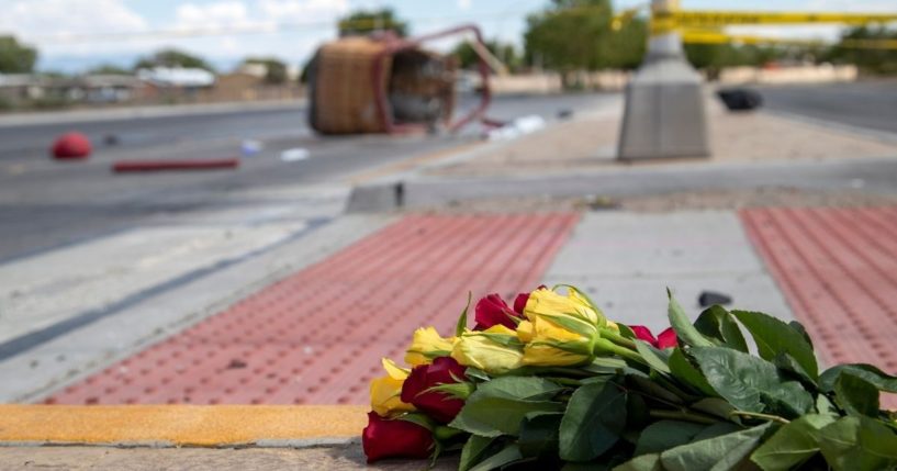 A bouquet of flowers from a mourner is placed near the basket of a hot air balloon that crashed in Albuquerque, New Mexico, on Saturday. Police said the five occupants died after it crashed onto the busy street.