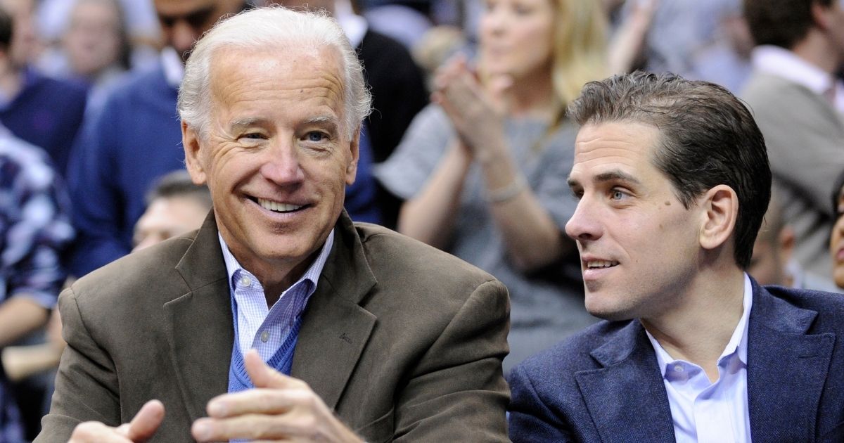 Then-Vice President Joe Biden, left, sits with his son Hunter, right, at the Duke Georgetown NCAA college basketball game in Washington on Jan. 30, 2010.