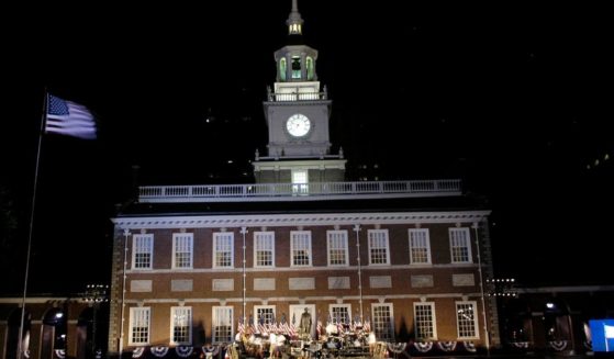 An American flag flies over the building after the re-lighting of Independence Hall on July 3, 2005, in Philadelphia.