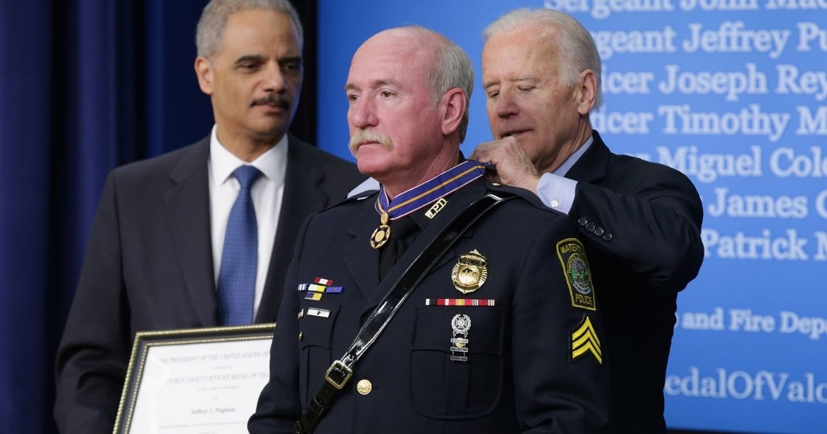 Then-Vice President Joe Biden awards Watertown, Massachusetts, police Sgt. Jeffrey Pugliese with the Medal of Valor during a ceremony at the Eisenhower Executive Office Building on Feb. 11, 2015, in Washington, D.C.