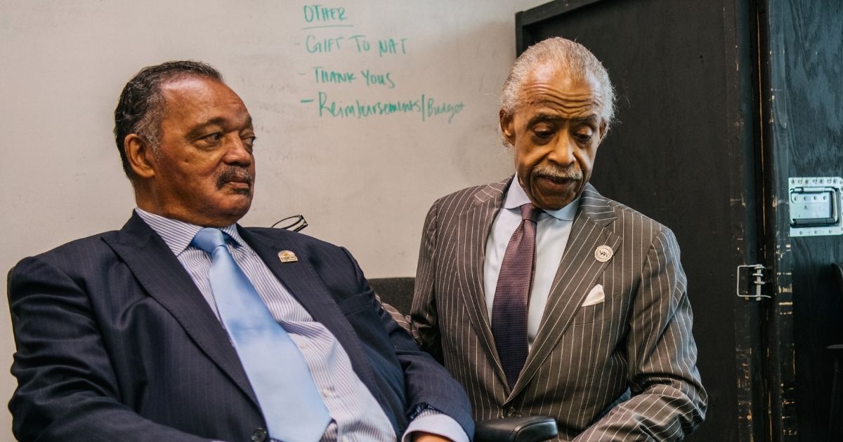 The Rev. Jesse Jackson and the Rev. Al Sharpton spend time together ahead of a rally during commemorations of the 100th anniversary of the Tulsa Race Massacre on Tuesday in Tulsa, Oklahoma.