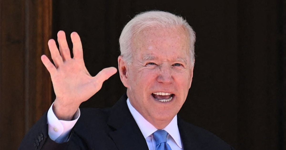 President Joe Biden waves at reporters as he arrives at the Villa La Grange in Geneva on Wednesday.