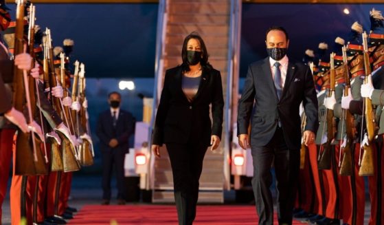 Vice President Kamala Harris walks with Guatemalan Minister of Foreign Affairs Pedro Brolo as she exits Air Force Two on arrival in Guatemala City on Sunday at Guatemala's Air Force Central Command.