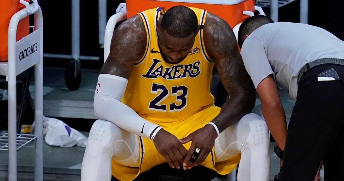 Los Angeles Lakers forward LeBron James sits on the bench during the fourth quarter of Game 6 of his team's first-round playoff series against the Phoenix Suns on Thursday at Staples Center.