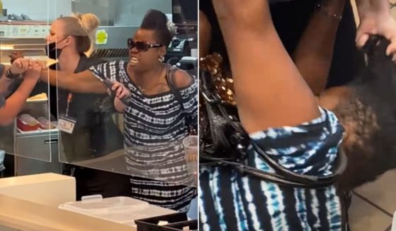A woman identified by police as Cherysse Cleveland fights with employees at a McDonald's in Ravenna, Ohio.