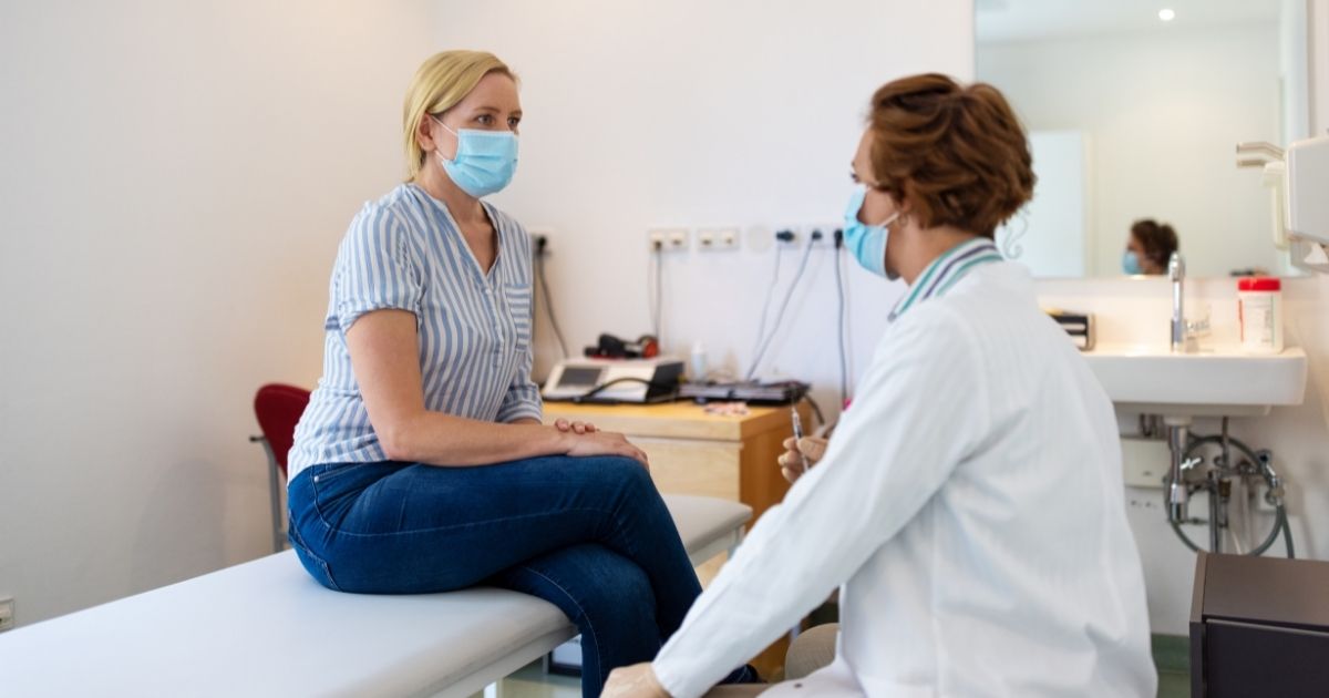 This stock photo portrays a white woman speaking with her doctor. An article published this month in the Journal of the American Psychoanalytic Association argues that "whiteness" is a mental condition.