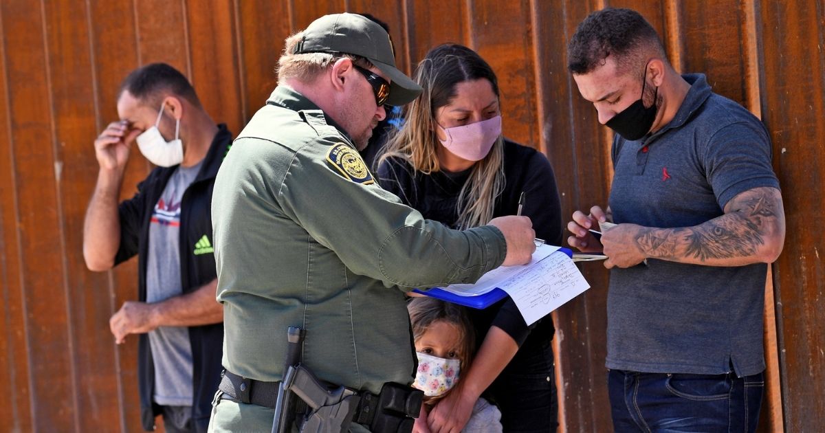 Migrants who illegally crossed into the U.S. from Mexico are detained by U.S. Customs and Border Protection in San Luis, Arizona, on May 21.
