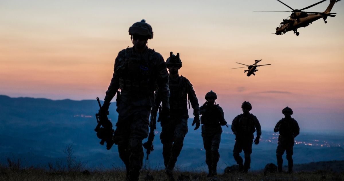 On Fox News' Tucker Carlson's show, investigative journalist Daniel Greenfield says what his research looking into the workings of the "woke" Pentagon has revealed. The above stock photo shows a military mission at twilight.