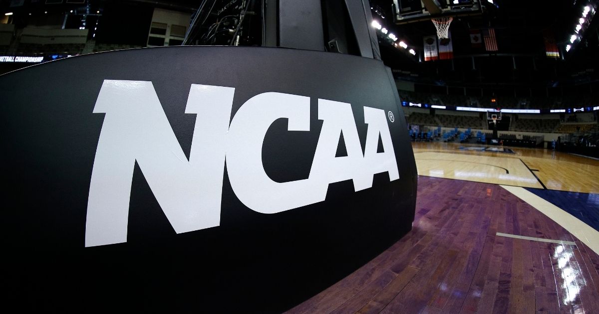 The NCAA logo is seen on the basket stanchion before the game between the Oral Roberts Golden Eagles and the Florida Gators in the second-round game of the 2021 NCAA Men's Basketball Tournament at Indiana Farmers Coliseum on March 21, 2021, in Indianapolis.