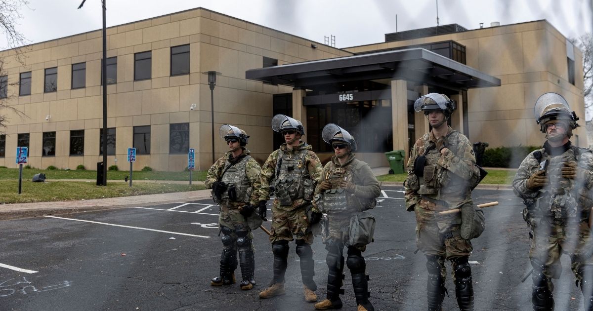 Minnesota National Guard and State Troopers stand guard outside the Brooklyn Center Police Station after a police officer shot and killed 20-year-old Daunte Wright during a traffic stop in Brooklyn Center, Minneapolis on April 12, 2021.