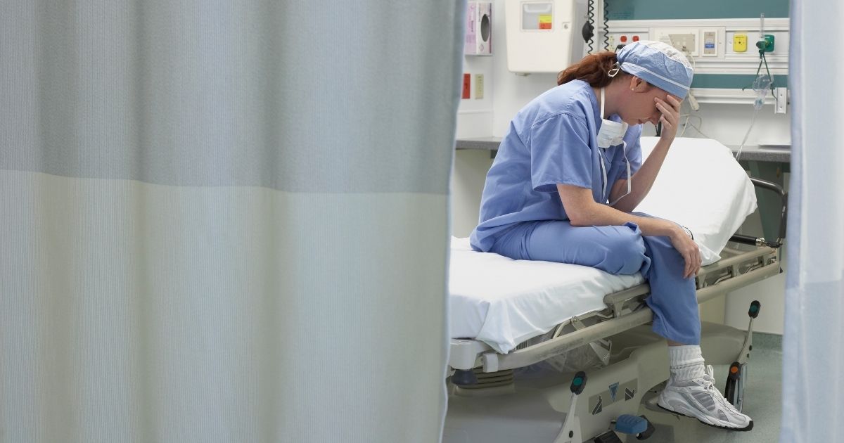 This stock photo portrays a nurse sitting in a hospital bed. The Houston Methodist Hospital is reportedly threatening employees with termination if they do not receive the COVID-19 vaccine.