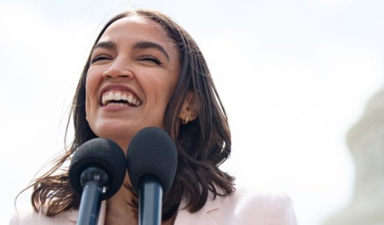 Democratic Rep. Alexandria Ocasio-Cortez of New York smiles during a news conference outside the Capitol in Washington on April 15.