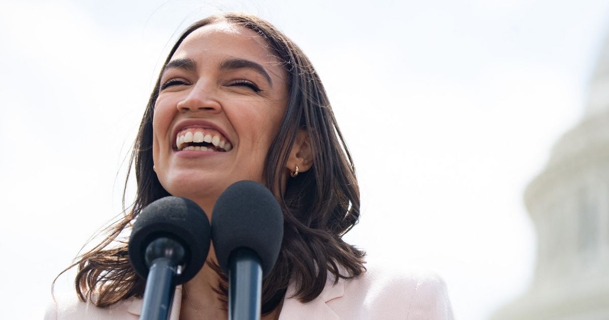 Democratic Rep. Alexandria Ocasio-Cortez of New York smiles during a news conference outside the Capitol in Washington on April 15.