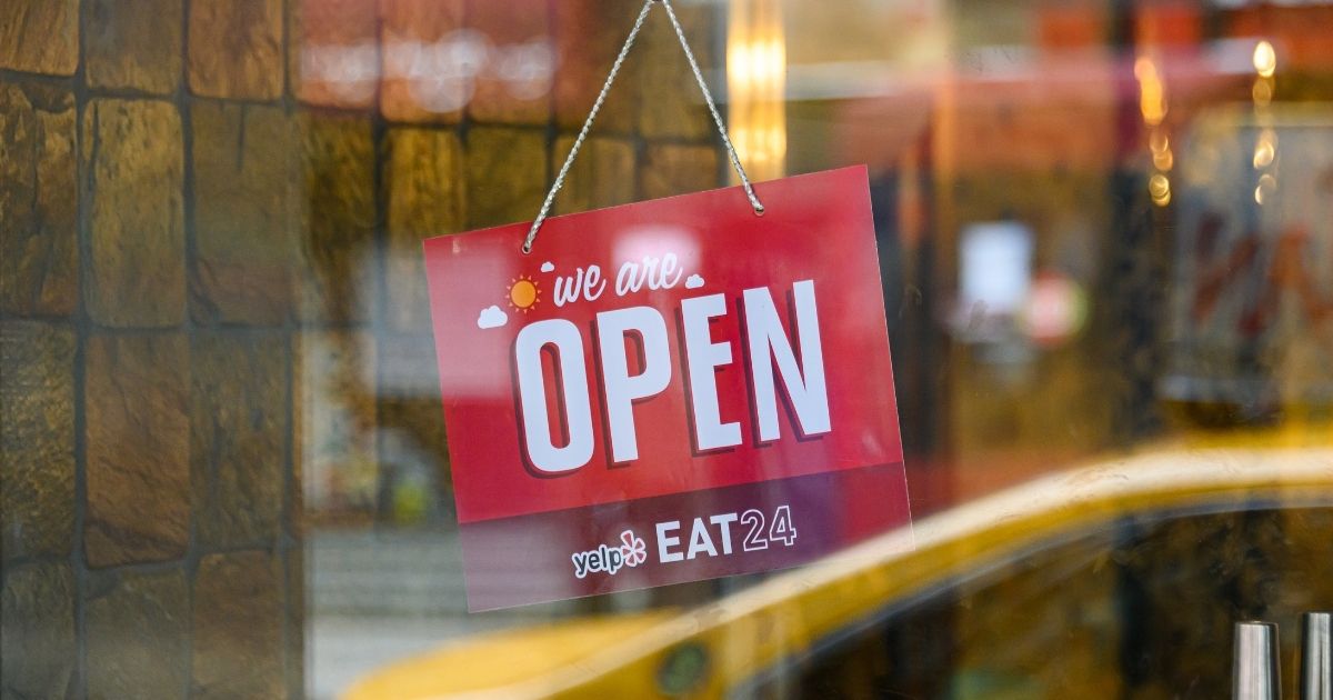 A "We Are Open" sign is seen outside a restaurant in Kips Bay on April 27, 2020, in New York City.