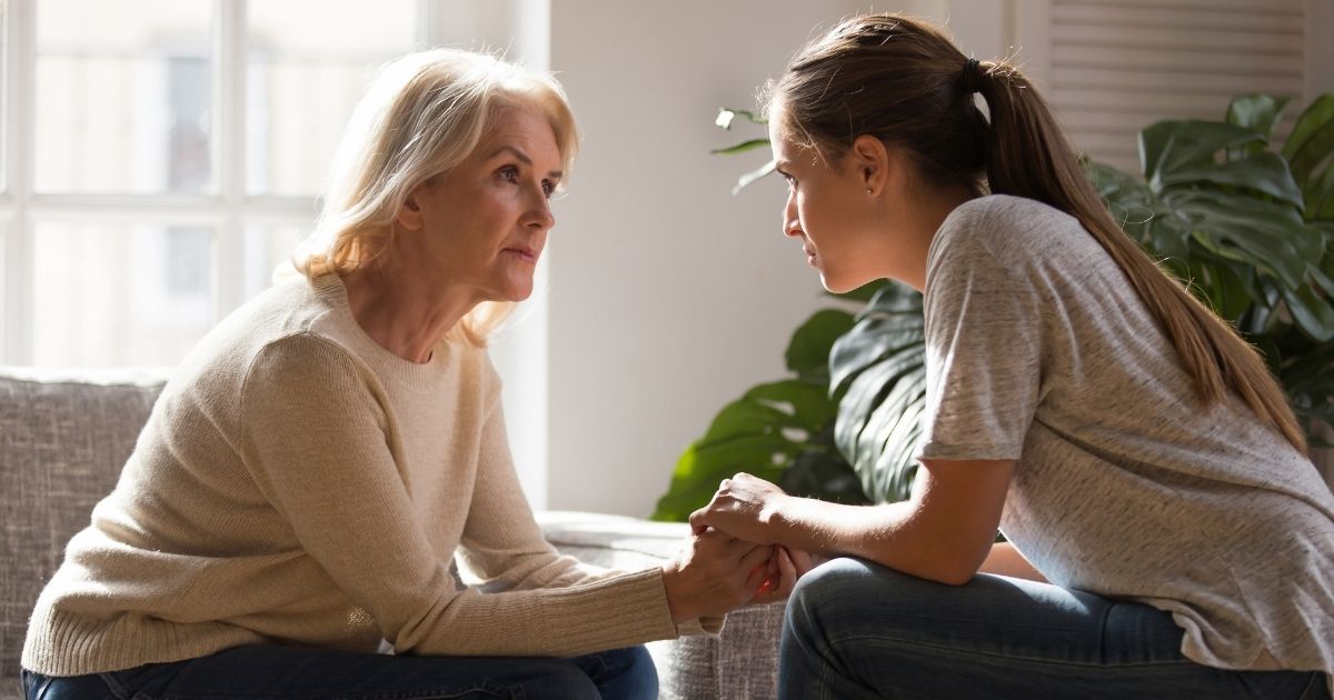 This stock photo portrays two women, of different ages, holding hands in the middle of a conversation. A new bill going into effect on Sept. 1 in Texas will allow families to request the advice of multiple medical professionals before courts can rule to separate a child from their family on the grounds of child abuse.