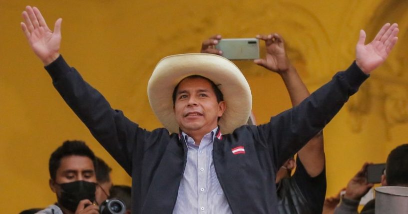 Peruvian presidential candidate Pedro Castillo gestures at supporters from a balcony of his party's headquarters in Lima on June 7.
