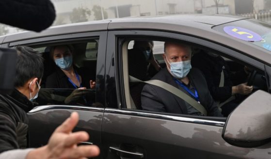 Peter Daszak, right, and other members of the World Health Organization team investigating the origins of the coronavirus arrive at the Wuhan Institute of Virology in Wuhan in China's central Hubei province on Feb. 3, 2021.