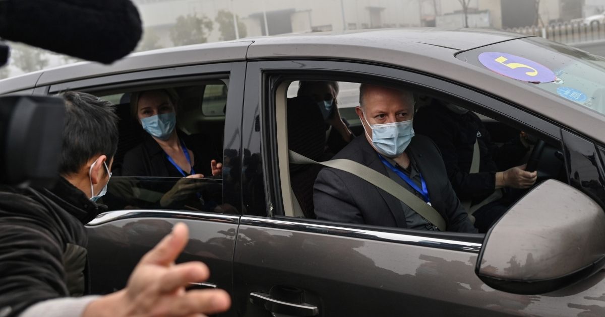 Peter Daszak, right, and other members of the World Health Organization team investigating the origins of the coronavirus arrive at the Wuhan Institute of Virology in Wuhan in China's central Hubei province on Feb. 3, 2021.