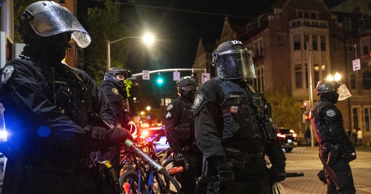 Portland police stand guard as tensions rise with a small group of protesters on April 20, 2021 in Portland, Oregon.