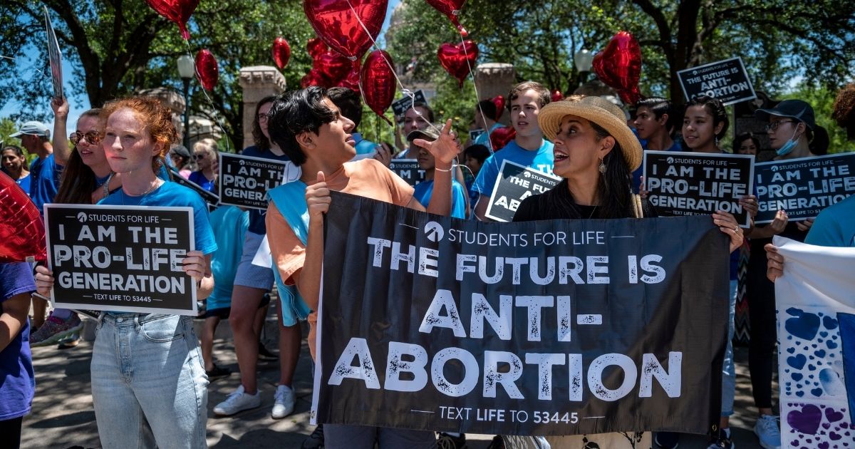 Pro-life demonstrators stand near the gate of the Texas state capitol on May 29, 2021, in Austin, Texas.