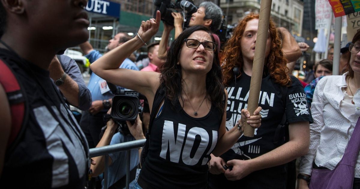 Sunsara Taylor, center, leads protesters from RefuseFascism.org outside of Trump Tower on Aug. 14, 2017, in New York City.